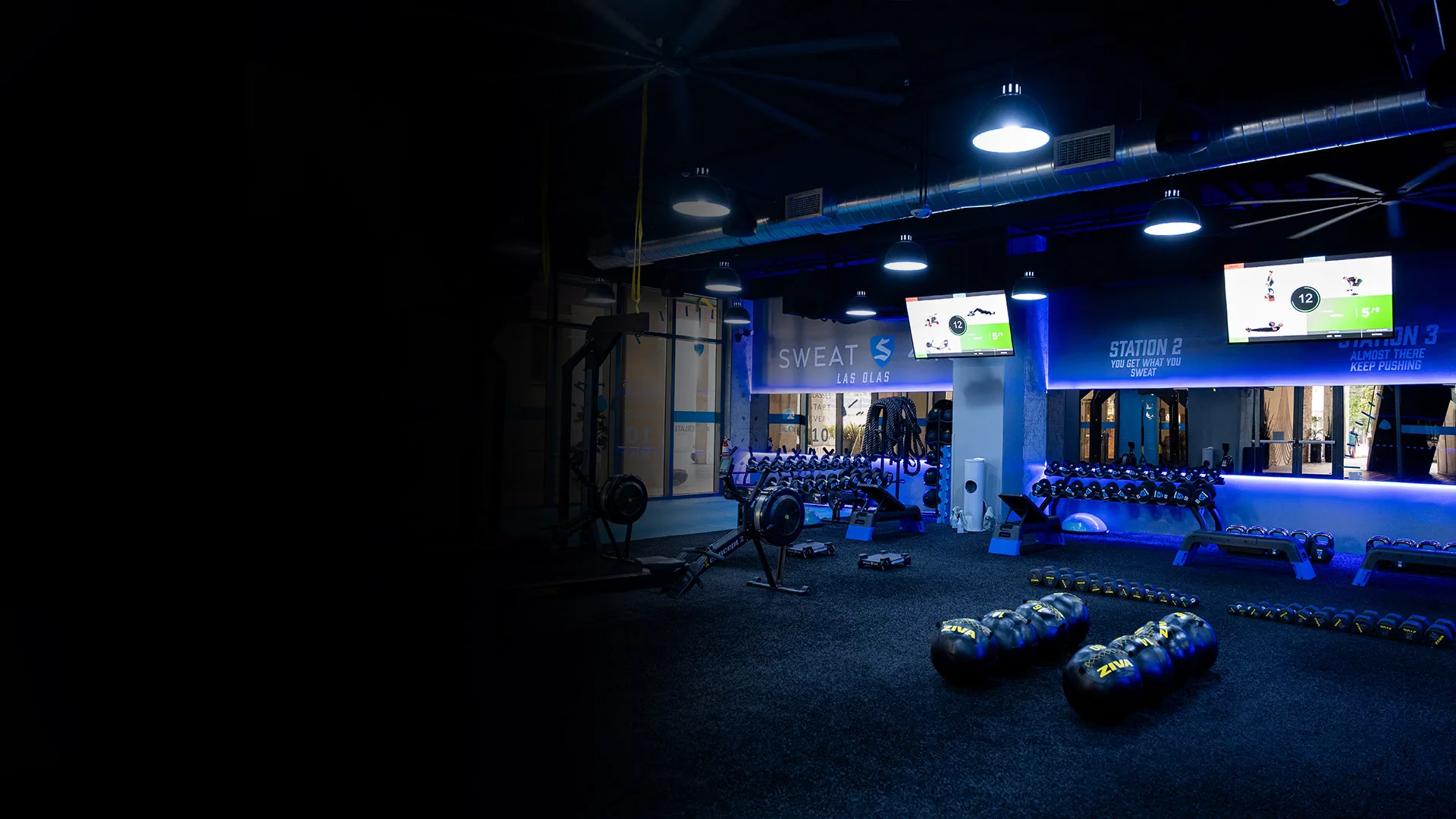 Inside a SWEAT440 franchise studio with training stations and equipment ready for class